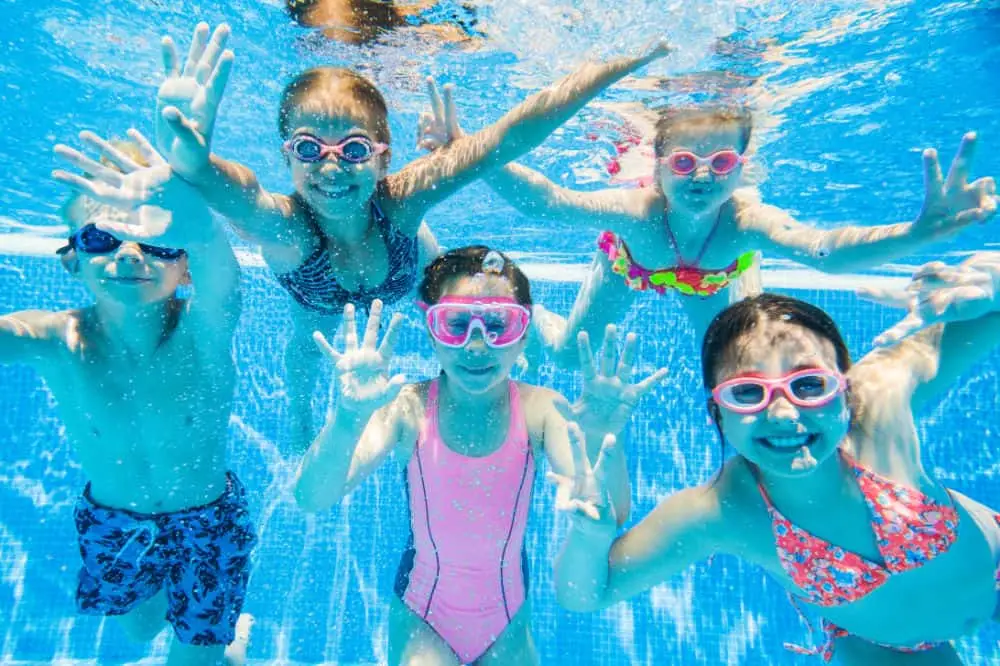 Kids swimming underwater in a clean backyard pool in Charlotte, NC